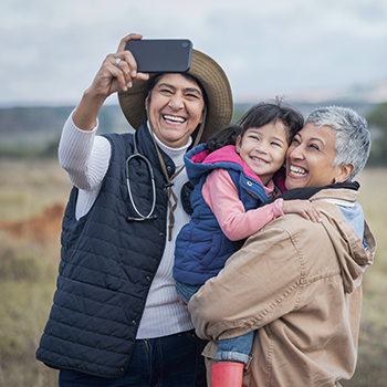 Two ladies and little girl taking a selfie in the countryside